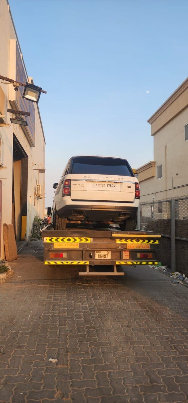 A Range Rover loaded on a recovery truck for collection, on its way to the GAS AUTO workshop
